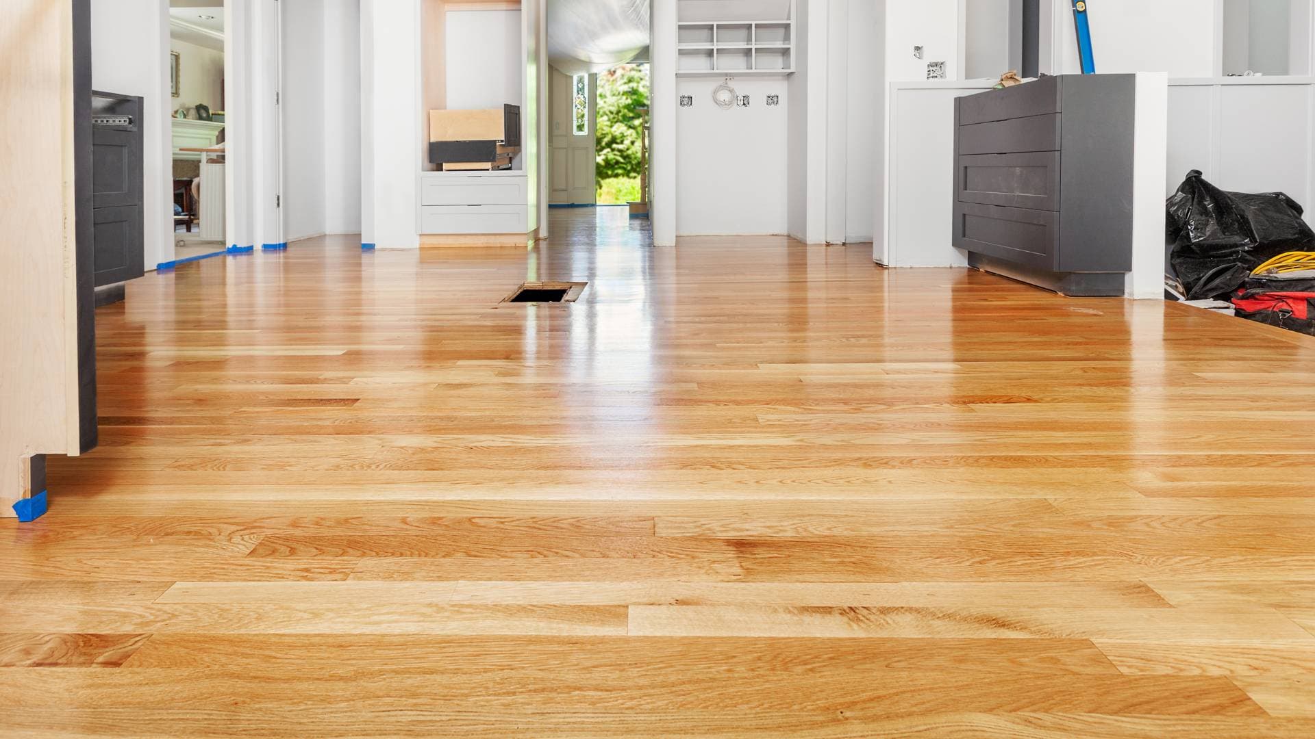 Newly laid hardwood flooring running through an open-plan room
