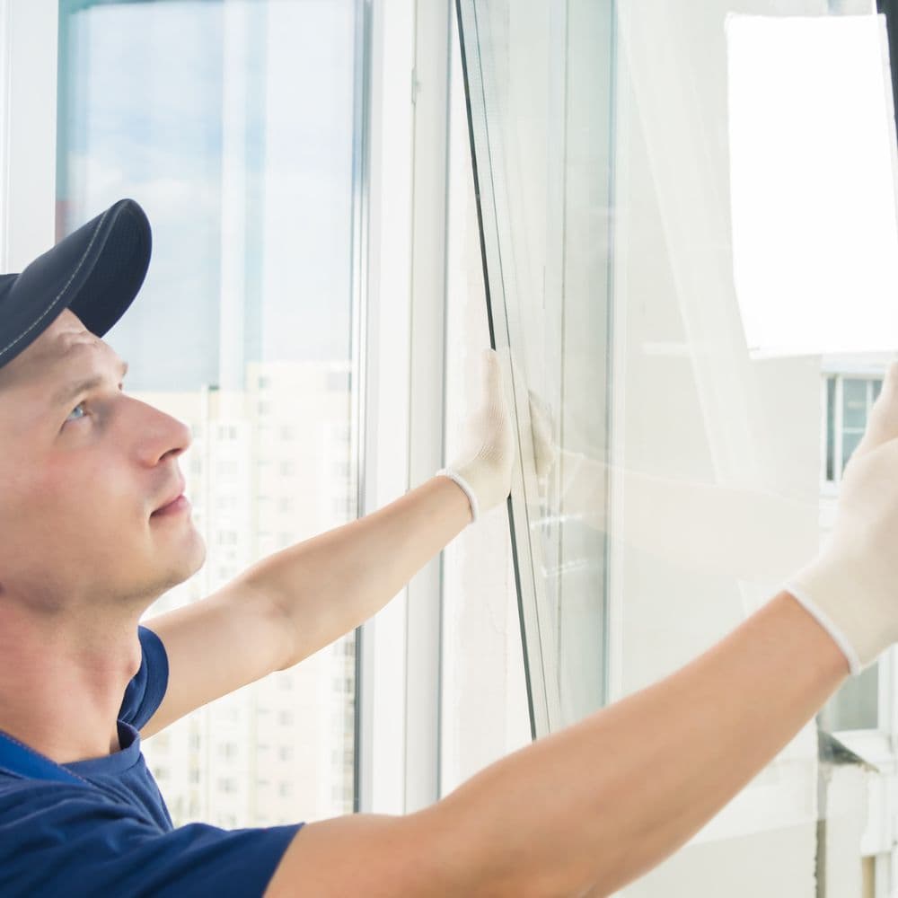 Installer positioning a replacement window sash