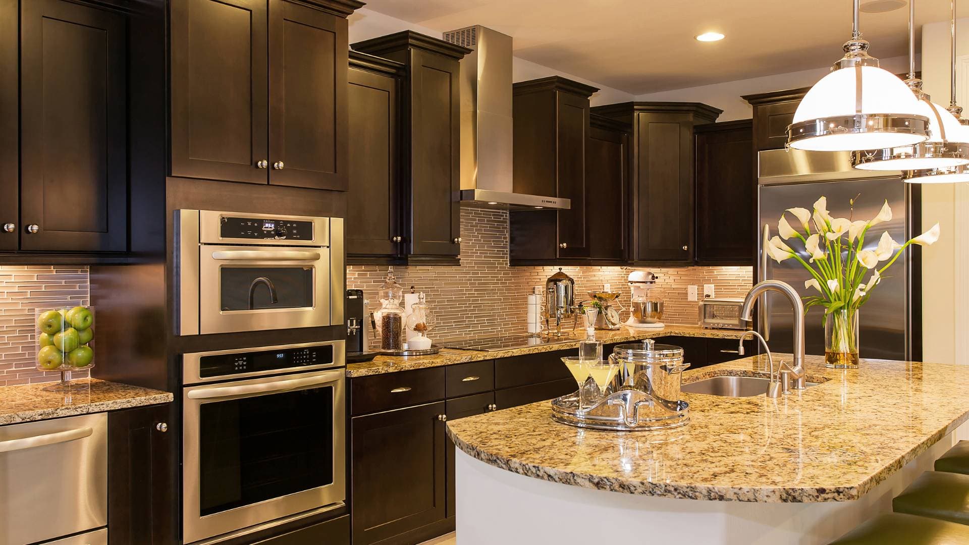 Traditional kitchen with dark cabinetry and a granite island